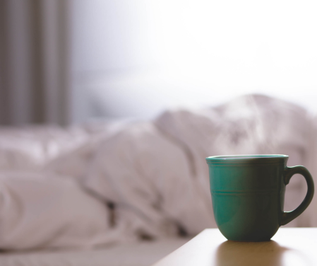 homeopathy for insomnia and sleep problems unmade bed and a mug of coffee